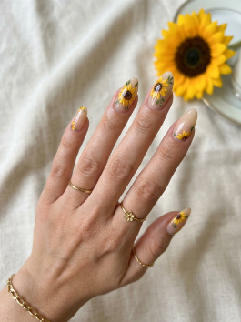 2. Nude Sunflower Nail Designs
